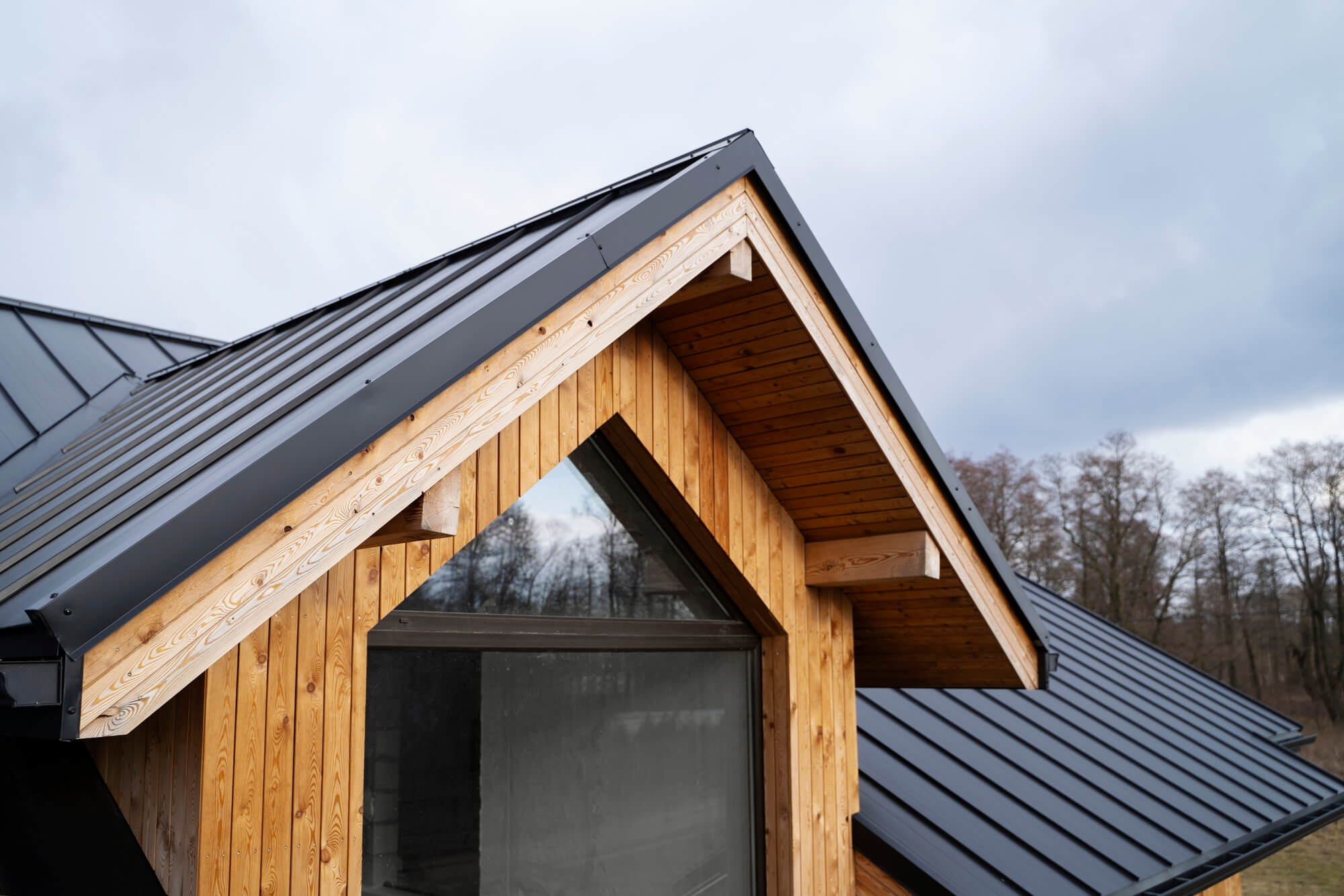 A Roof With Black Tinted Window And Wooden Frame